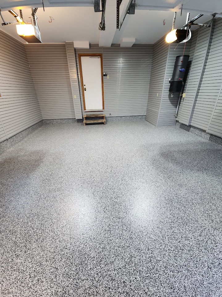 Grey slatwall installed around a finished garage with a coated floor